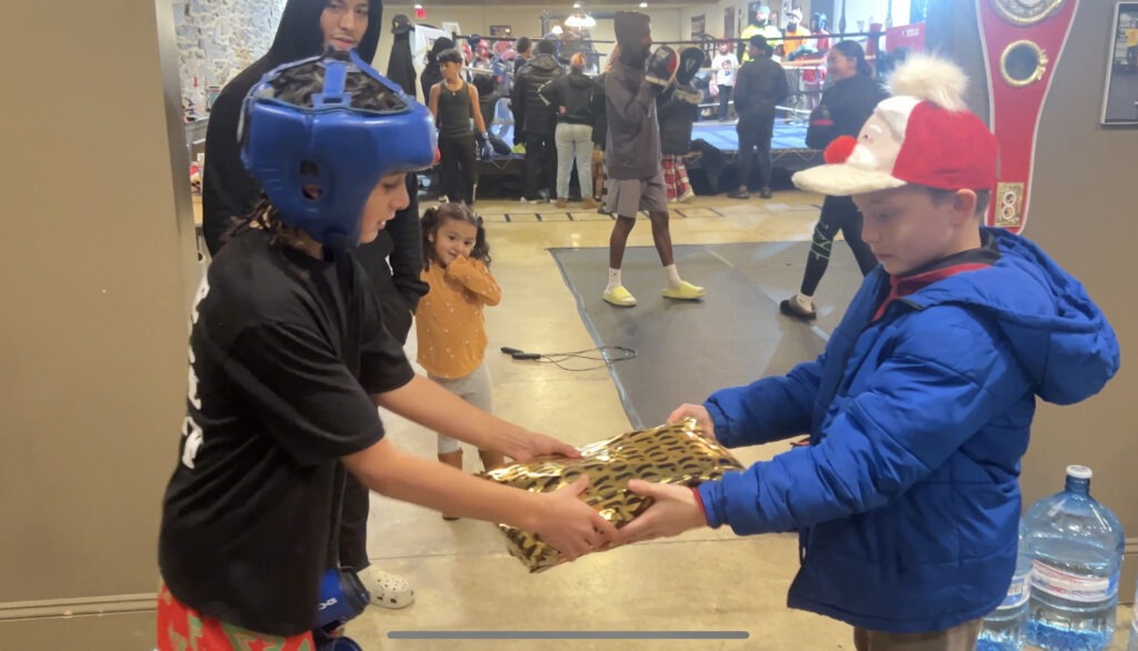 X delivers his first X-Caliber X-Mas gift to youth boxer Christopher Baby Goat Lugo Jr